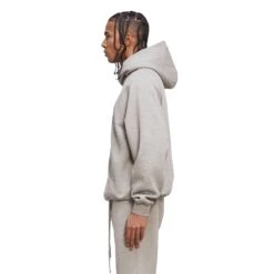 Fear Of God Essentials Heather Oatmeal Hoodie 8 Fear Of God Essentials Heather Oatmeal Hoodie -Creps Lockers Fear Of God Essentials Heather Oatmeal Hoodie Crepslocker model side