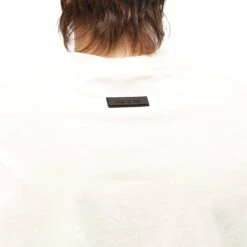 Fear Of God Essentials Cloud Dancer T Shirt (FW23) 10 Fear Of God Essentials Cloud Dancer T Shirt (FW23) -Creps Lockers fear of god essentials cloud dancer t shirt fw23 model back detail