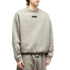 Fear Of God Essentials Dark Heather Oatmeal Crewneck (FW23) -Creps Lockers fear of god essentials dark heather oatmeal crewneck fw23 192sp244683f model front