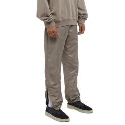 Fear Of God Essentials Desert Taupe Track Pants (FW23) -Creps Lockers fear of god essentials desert taupe track pants fw23 130bt212161f model side