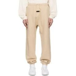 Fear Of God Essentials Gold Heather Sweatpants (FW23) 9 Fear Of God Essentials Gold Heather Sweatpants (FW23) -Creps Lockers fear of god essentials gold heather sweatpants fw23 model front