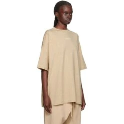 Fear Of God Essentials Gold Heather T Shirt (FW23) -Creps Lockers fear of god essentials gold heather t shirt fw23 125bt232003f model side