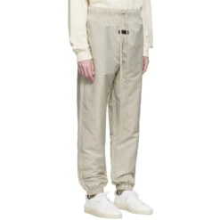 Fear Of God Essentials Smoke Track Pants (FW22) -Creps Lockers fear of god essentials smoke track pants fw22 130su222161f model side