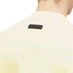Fear Of God Essentials SS Garden Yellow T Shirt (FW23) -Creps Lockers fear of god essentials ss garden yellow t shirt fw23 125sp244191f model detail