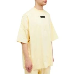 Fear Of God Essentials SS Garden Yellow T Shirt (FW23) -Creps Lockers fear of god essentials ss garden yellow t shirt fw23 125sp244191f model side